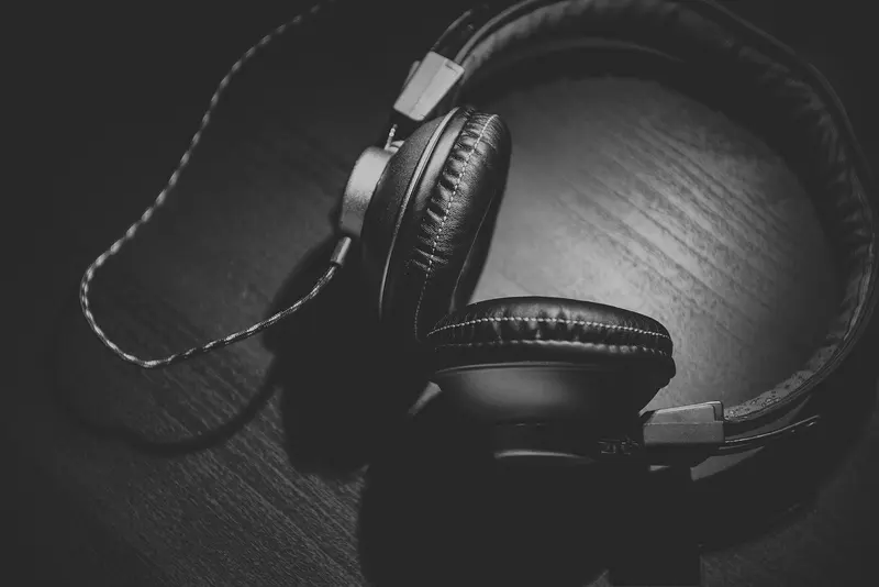 A pair of over-ear headphones on a wooden table