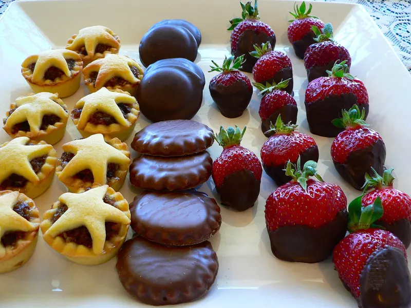 A plate of mince pies, chocolate biscuits and chocolate-dipped strawberries