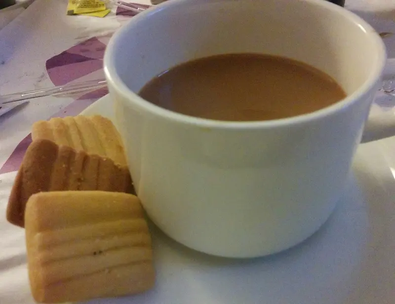 A cup of tea with shortbread biscuits on a saucer