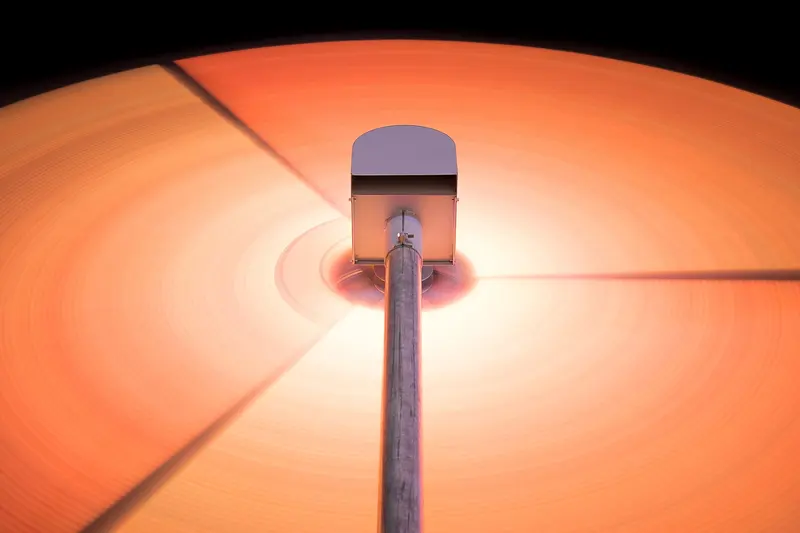 An orange vinyl record spinning under a turntable stylus