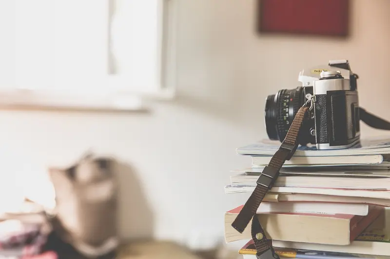 A film camera resting on a stack of books