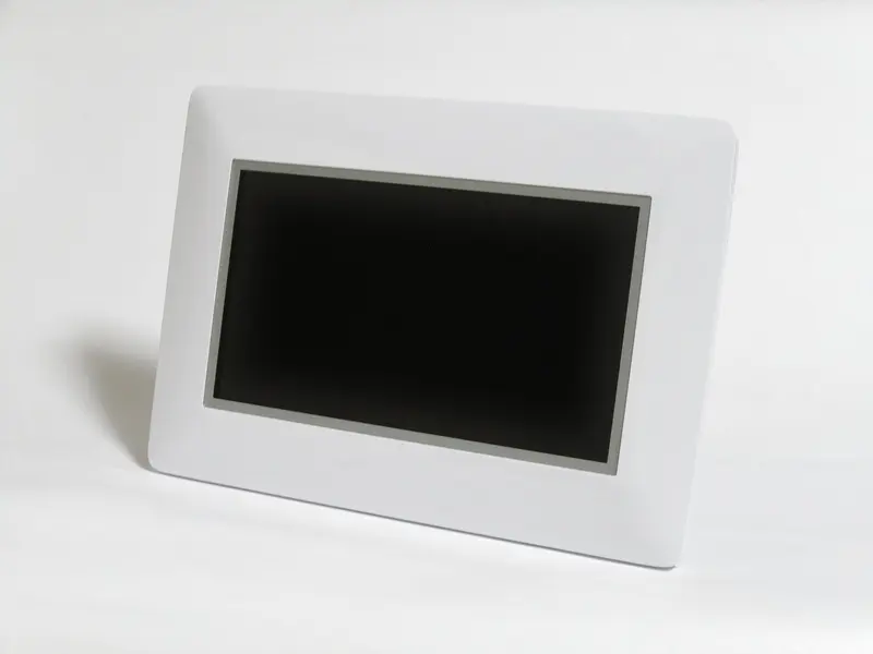 A white digital photo frame on a white surface