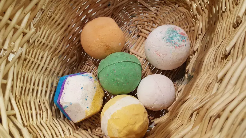 A wicker basket of colourful bath bombs